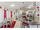 Well-lit kitchen and dining area with modern appliances, gray cabinetry, and decorative accents at 5188 Elwood Rd, Spring Hill, FL 34608