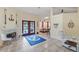 Sunlit living room boasting tile flooring, a decorative fireplace, and access to the pool area at 5188 Elwood Rd, Spring Hill, FL 34608
