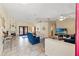 Inviting living room with tile flooring, nautical decor, comfortable seating, and a view of the outdoor pool area at 5188 Elwood Rd, Spring Hill, FL 34608