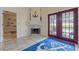 Elegant living space features tile floors, a fireplace, and French doors leading to the pool area at 5188 Elwood Rd, Spring Hill, FL 34608