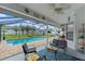 Screened-in patio space with comfortable seating, a ceiling fan, and a view of the pool area at 5188 Elwood Rd, Spring Hill, FL 34608