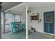 Casual screened-in patio setup with a bar, dartboard, and themed decorations at 5188 Elwood Rd, Spring Hill, FL 34608