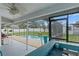 Screened-in patio offers bar seating with views of the pool, backyard, and surrounding landscape at 5188 Elwood Rd, Spring Hill, FL 34608