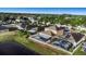Aerial photo shows the house has a pool, screened in porch, and is located by a lake in a neighborhood at 1739 Broad Winged Hawk Dr, Ruskin, FL 33570