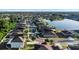 Aerial view of homes in a community with a lake and lush lawns with landscaping, with views of trees and lawns at 1739 Broad Winged Hawk Dr, Ruskin, FL 33570