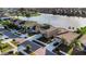 Aerial view of a two-story home with a spacious driveway and serene lake view at 1739 Broad Winged Hawk Dr, Ruskin, FL 33570