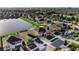 Aerial view of a two-story home with a spacious driveway and pond view at 1739 Broad Winged Hawk Dr, Ruskin, FL 33570