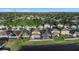 Aerial view of a two-story home with screened in pool, lush lawn and landscaping in a lakefront community at 1739 Broad Winged Hawk Dr, Ruskin, FL 33570