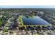 Wide aerial view of homes in a community with lakes and lush lawns, landscaping, trees and manicured green spaces at 1739 Broad Winged Hawk Dr, Ruskin, FL 33570