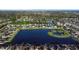 Wide aerial shot showcases a residence next to a pond with an island in a well-maintained neighborhood at 1739 Broad Winged Hawk Dr, Ruskin, FL 33570