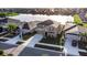 Aerial view of a two-story home with a two car garage, lush lawn and landscaping in a lakefront community at 1739 Broad Winged Hawk Dr, Ruskin, FL 33570
