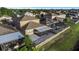 Aerial view of a backyard with a screened lanai, patio, and white picket fence at 1739 Broad Winged Hawk Dr, Ruskin, FL 33570