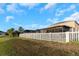 The backyard features a white fence, screened-in lanai, and plenty of green space at 1739 Broad Winged Hawk Dr, Ruskin, FL 33570