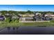 Aerial view of backyard with screened in patio facing large pond at 1739 Broad Winged Hawk Dr, Ruskin, FL 33570