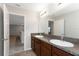 Well-lit bathroom featuring double sinks, granite countertops, and a spacious vanity for added convenience at 1739 Broad Winged Hawk Dr, Ruskin, FL 33570
