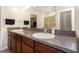 Bathroom featuring double sinks, granite countertops, and a large mirror at 1739 Broad Winged Hawk Dr, Ruskin, FL 33570