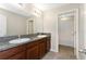 Bathroom featuring double sinks, granite countertops, and a walk-in shower at 1739 Broad Winged Hawk Dr, Ruskin, FL 33570