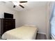 Bedroom with ceiling fan, hard wood floors, and windows with gray curtains at 1739 Broad Winged Hawk Dr, Ruskin, FL 33570