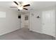 A bright bedroom with a ceiling fan, carpet, and decorative shelves for a personal touch at 1739 Broad Winged Hawk Dr, Ruskin, FL 33570
