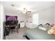 Bedroom featuring a large bed, computer, and dual monitors for a gaming enthusiast at 1739 Broad Winged Hawk Dr, Ruskin, FL 33570
