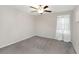 A simple yet calming bedroom with neutral walls, plush carpet, and ceiling fan at 1739 Broad Winged Hawk Dr, Ruskin, FL 33570