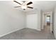 This bedroom offers a ceiling fan, closet with folding doors and plush carpet at 1739 Broad Winged Hawk Dr, Ruskin, FL 33570