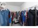 Walk-in closet with wire shelving and hanging clothes at 1739 Broad Winged Hawk Dr, Ruskin, FL 33570