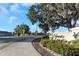 Hawks Landing community entrance sign with lush landscaping and a pedestrian crossing for neighborhood accessibility at 1739 Broad Winged Hawk Dr, Ruskin, FL 33570