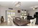 Bright dining room features a large wooden table, white chairs, and sliding glass doors to the backyard at 1739 Broad Winged Hawk Dr, Ruskin, FL 33570