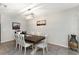 Dining room boasts a spacious wooden table with white chairs and pendant lighting at 1739 Broad Winged Hawk Dr, Ruskin, FL 33570
