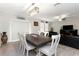 Dining area with a large table and living room in the background at 1739 Broad Winged Hawk Dr, Ruskin, FL 33570