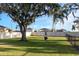 A dog park sits in a grassy field with trees and a white fence in the background at 1739 Broad Winged Hawk Dr, Ruskin, FL 33570