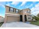 Inviting home boasts a well-manicured lawn, charming architectural details, and a convenient two-car garage at 1739 Broad Winged Hawk Dr, Ruskin, FL 33570