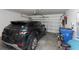 Clean garage with car, storage and open door at 1739 Broad Winged Hawk Dr, Ruskin, FL 33570