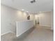 Hallway with neutral walls and plush carpet leading to the bedrooms and bathroom at 1739 Broad Winged Hawk Dr, Ruskin, FL 33570
