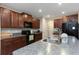Modern kitchen with rich cabinetry, granite countertops, and stainless steel appliances for culinary enthusiasts at 1739 Broad Winged Hawk Dr, Ruskin, FL 33570