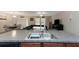 Kitchen with granite countertops and stainless steel sink open to living room at 1739 Broad Winged Hawk Dr, Ruskin, FL 33570
