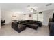 Spacious living area featuring a large sectional, adjacent to the dining area and sliding glass doors at 1739 Broad Winged Hawk Dr, Ruskin, FL 33570