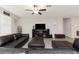 Inviting living room with a plush black leather sofa and a ceiling fan for added comfort at 1739 Broad Winged Hawk Dr, Ruskin, FL 33570