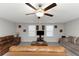 Spacious living room with multiple couches, ceiling fan, and a stone coffee table at 1739 Broad Winged Hawk Dr, Ruskin, FL 33570