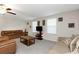 Spacious living room with multiple couches, ceiling fan, and a stone coffee table at 1739 Broad Winged Hawk Dr, Ruskin, FL 33570