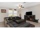 Comfortable living room with a large leather sectional sofa, media center, and ample natural light at 1739 Broad Winged Hawk Dr, Ruskin, FL 33570