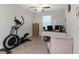 Functional home office with exercise equipment, desk and chair at 1739 Broad Winged Hawk Dr, Ruskin, FL 33570