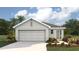 Charming single-story home featuring a two-car garage, well-maintained landscaping, and a welcoming front entrance at 30851 Wild Juniper Ct, Brooksville, FL 34602