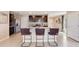 Modern kitchen featuring stainless steel appliances, dark cabinets, and a stylish breakfast bar with seating at 30863 Wild Juniper Ct, Brooksville, FL 34602