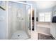 Well-lit bathroom with glass shower, bathtub, and coordinated tile and paint at 3389 Pennyroyal Rd, Port Charlotte, FL 33953