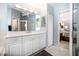 Bright bathroom features large vanity and walk-in shower with view of bedroom at 3389 Pennyroyal Rd, Port Charlotte, FL 33953