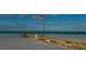 Seaside scenery showing the American flag and brick barricades on a beautiful sandy shore at 3389 Pennyroyal Rd, Port Charlotte, FL 33953