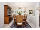 Inviting dining room features a large wooden table, hutch, and shuttered windows at 3389 Pennyroyal Rd, Port Charlotte, FL 33953