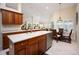 Spacious kitchen boasts ample counter space, wooden cabinets, and an adjacent dining area at 3389 Pennyroyal Rd, Port Charlotte, FL 33953